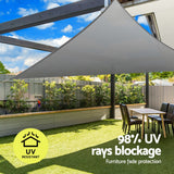 Grey triangle shade sail tensioned overhead providing shaded coverage across a outdoor patio corner.