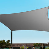 Grey 5x6m rectangular shade sail tensioned overhead providing shade across an outdoor patio deck.