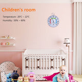 Children's room with a temperature and humidity gauge on the wall, a crib, and toys.