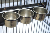 Large parrot aviary set up on a patio showing the castor wheels and internal feeding bowls