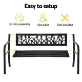 Black steel garden bench parts before assembly: backrest panel, slatted seat and side frames