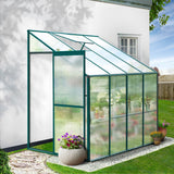 A compact 2.5m x 1.3m walk-in polycarbonate outdoor greenhouse with an aluminium frame and an open roof vent set up in an Australian backyard garden.