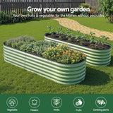 Green corrugated raised beds set up in an oval design in an Australian backyard