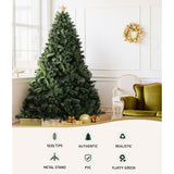 Fully decorated 8ft Jingle Jollys artificial xmas tree standing in an Australian living room.