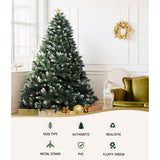 Fully decorated 8ft Jingle Jollys snow-frosted artificial xmas tree standing in an Australian living room.