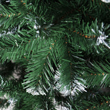 Close-up of snow-frosted PVC branch tips on an 8ft Jingle Jollys flocked fake Christmas tree.