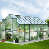 A large 5.1m x 2.4m walk-in polycarbonate outdoor greenhouse with a heavy-duty aluminium frame and dual roof vents set up in a backyard garden.