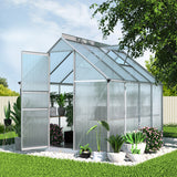 Walk-in polycarbonate greenhouse with aluminium frame set up in a backyard