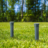 Sonic snake repeller spike installed in green lawn near home garden bed
