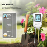 Dual probes of soil detector inserted into vegetable garden bed soil