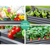 Galvanised raised garden bed filled with soil, growing lettuce, herbs, and strawberries